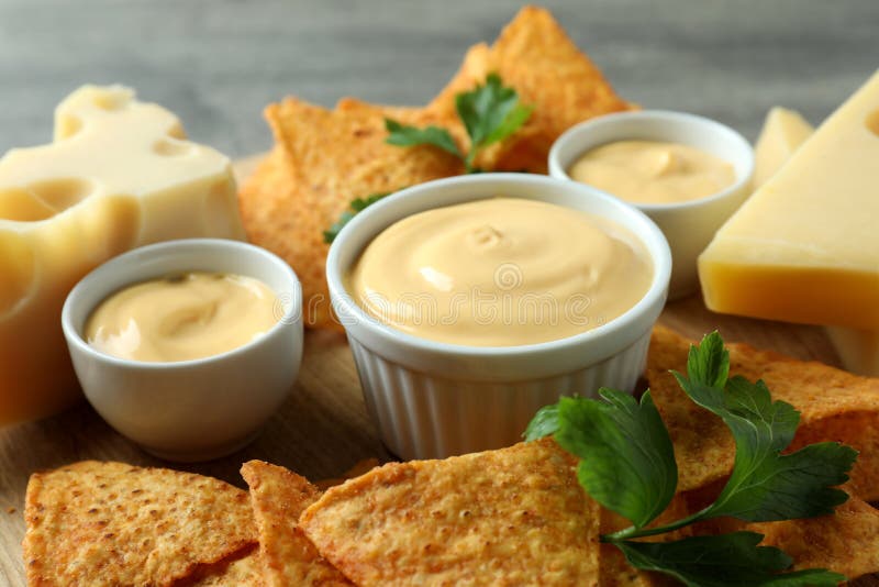 Concept of Snack with Chips and Cheese Sauce, Close Up Stock Photo