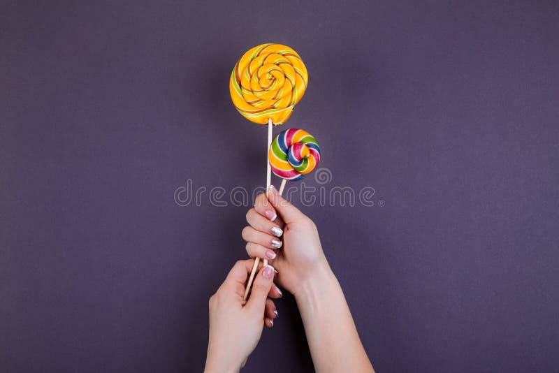 Two Lollypops on a Stick in Hand. Stock Image - Image of concept ...