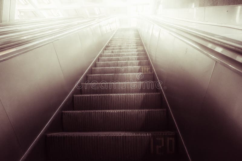 Concept of success in business, moving up the career path. Underground Escalator Conveor in Subway