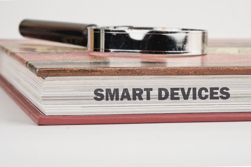The concept of technology and development. Phrase, words, text SMART DEVICES on the end of the book, a close-up front view.