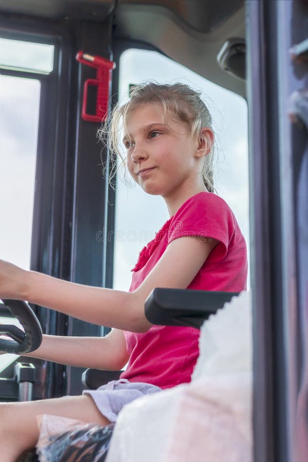 Concept. une fille aux cheveux blancs conduit un camion. égalité des femmes dans le choix d'une profession photos stock