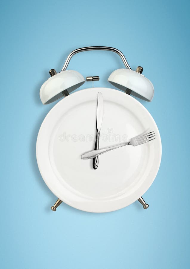 Concept of intermittent fasting, diet and weight loss. Plate as Alarm clock on blue. Concept of intermittent fasting, diet and weight loss. Plate as Alarm clock on blue