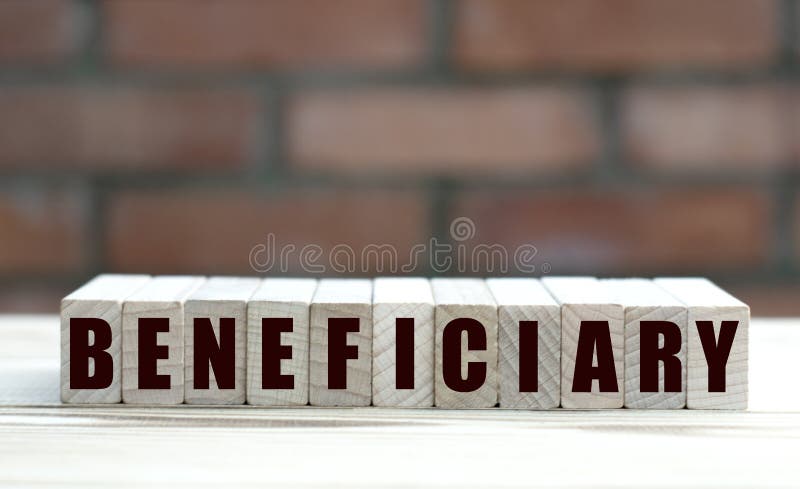 Concept word BENEFICIARY on cubes against the background of a brick wall. Business concept stock photography