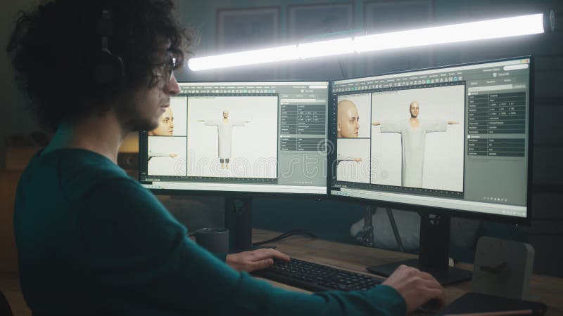 Man in glasses creating 3D human on computer while working on remote project at night at home. Man in glasses creating 3D human on computer while working on remote project at night at home