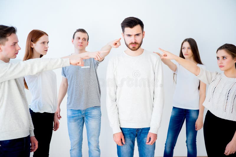 Concept of accusation - group of people pointing at a man. Concept of accusation - group of people pointing at a man