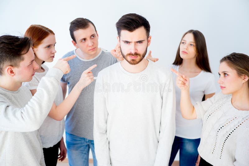 Concept of accusation - group of people pointing at a man. Concept of accusation - group of people pointing at a man