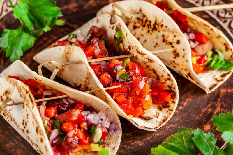 Concepto de cocina mexicana Tacos mexicanos del aperitivo con las verduras, habas, paprika, pimientas de chiles en el pan ácimo f imagen de archivo Concepto de cocina mexicana Tacos mexicanos del aperitivo con las verduras, habas, paprika, pimientas de chiles en el pan ácimo f imagen de archivo