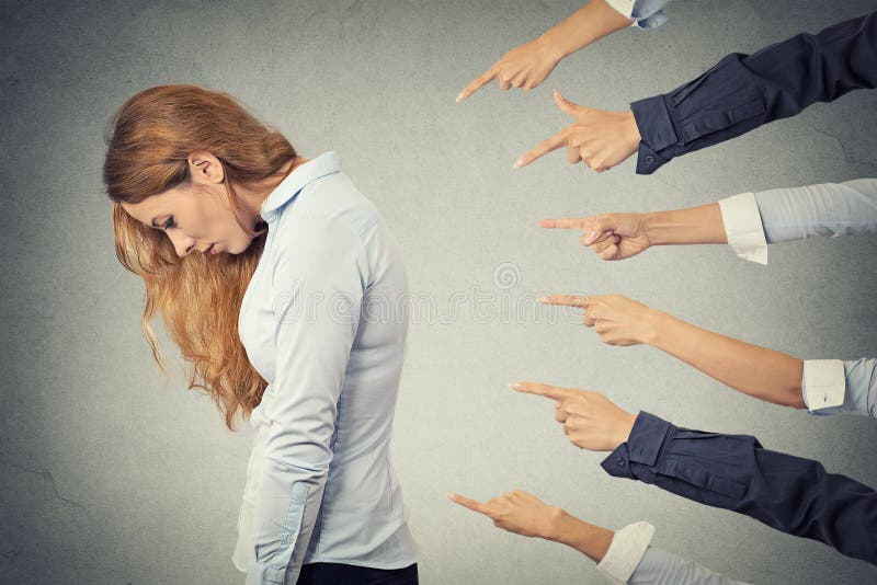 Concept of accusation guilty businesswoman person. Side profile sad upset woman looking down many fingers pointing at her isolated grey office background. Human face expression emotion feeling. Concept of accusation guilty businesswoman person. Side profile sad upset woman looking down many fingers pointing at her isolated grey office background. Human face expression emotion feeling