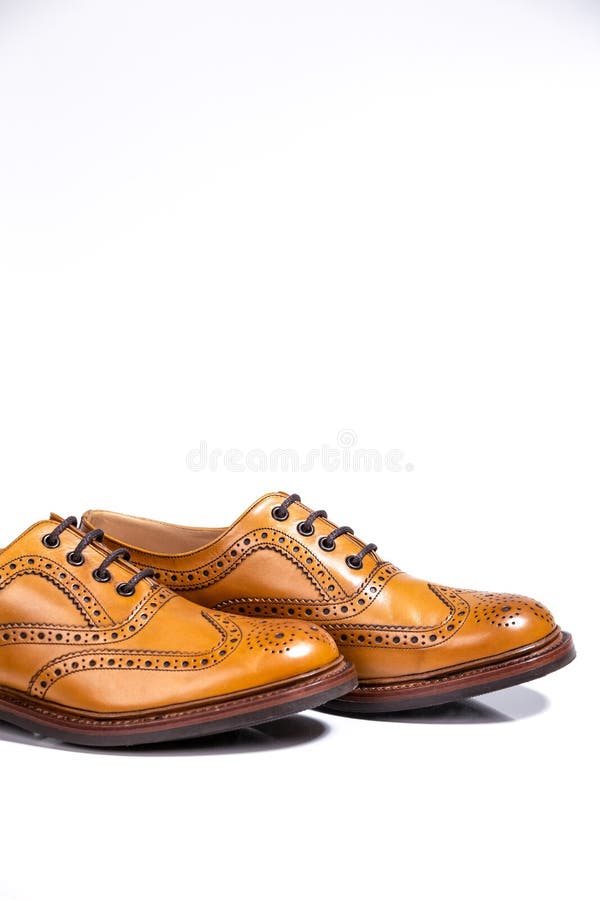Concepts of Luxury Male Footwear. A pair of Full Broggued Tan Leather Brogues stock photography Concepts of Luxury Male Footwear. A pair of Full Broggued Tan Leather Brogues stock photography