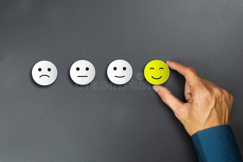 Conceptual the customer responded to the survey. The client using hand choose happy face smile icon. Depicts that customer is very