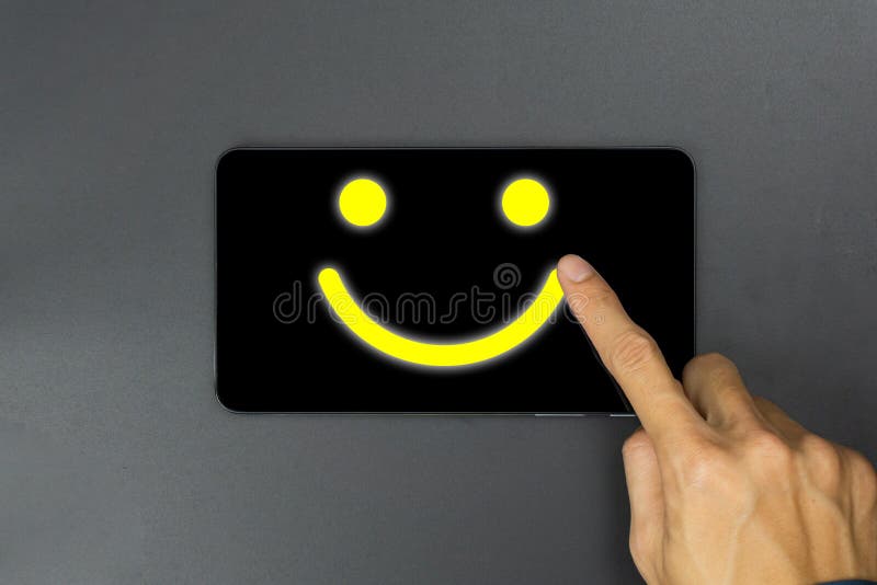 Conceptual the customer responded to the survey. The client using hand write happy face smile icon on tablet. Depicts that. Customer is very satisfied. Service stock photo Conceptual the customer responded to the survey. The client using hand write happy face smile icon on tablet. Depicts that. Customer is very satisfied. Service stock photo