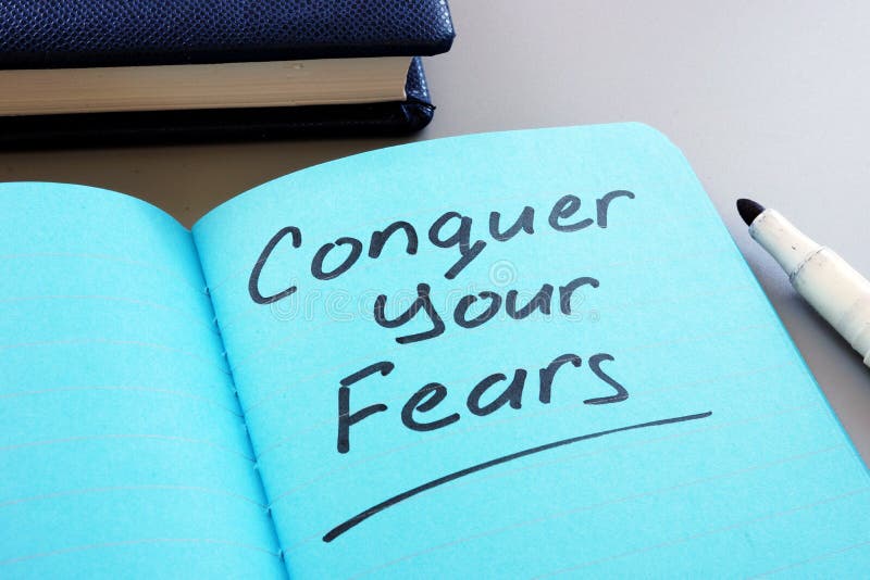 Conceptual hand writing text showing Conquer your fears stock photos
