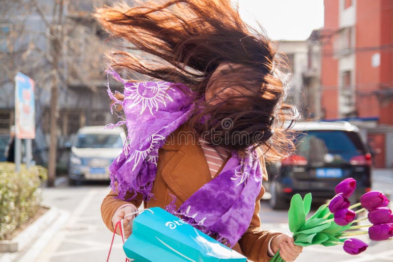 Conceptual photo about windy weather. The wind blows the girl`s hair.