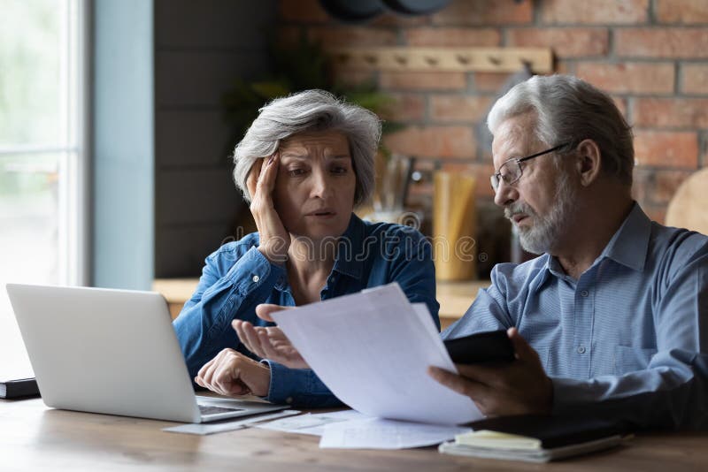 Concerned elderly couple discuss unpaid bank debt