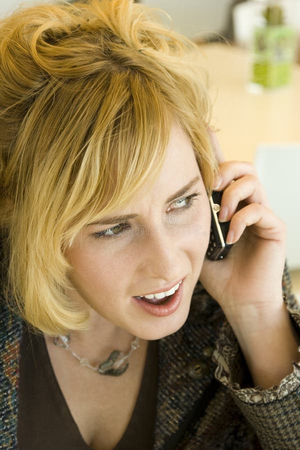 Concerned Young Blonde Woman on Mobile Phone stock photography Concerned Young Blonde Woman on Mobile Phone stock photography