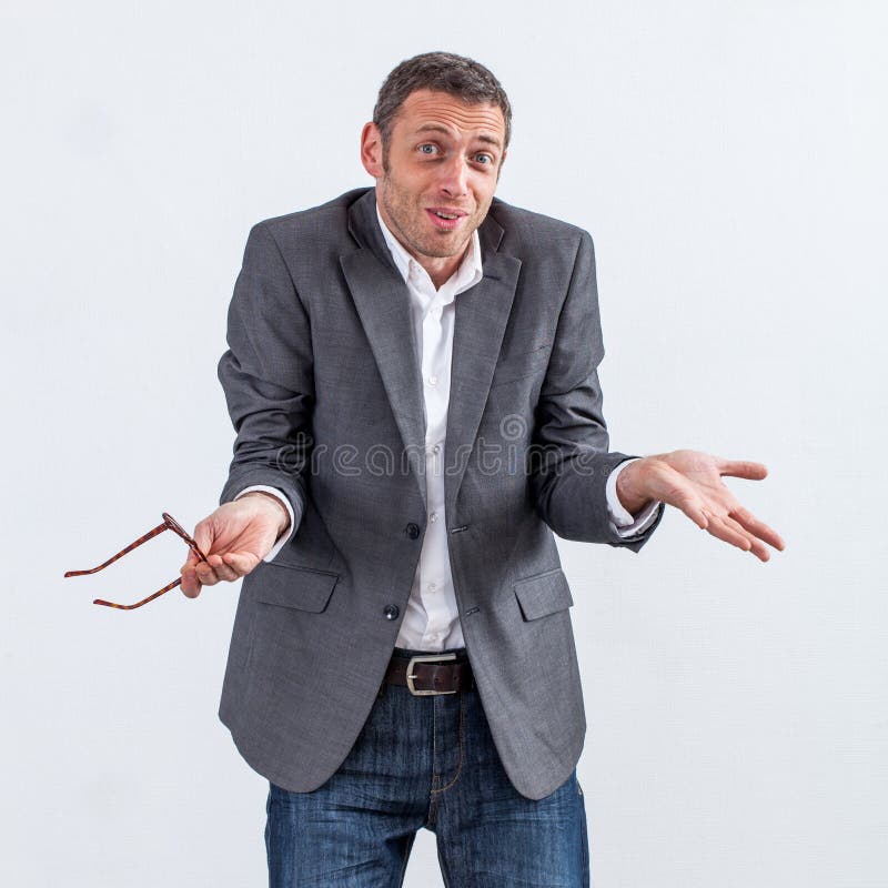 Corporate denial concept - denying 40s businessman shrugging with eyeglasses in hand apologizing for no responsibility in management mistake, white background. Corporate denial concept - denying 40s businessman shrugging with eyeglasses in hand apologizing for no responsibility in management mistake, white background