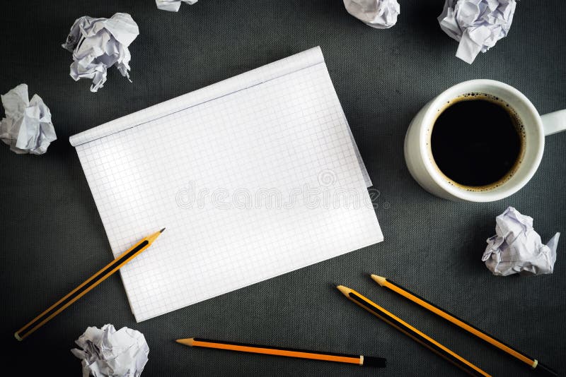 Creative Writing Concept With Pencils, Coffee Cup, Notepad and Crumpled Paper on Table, Top View. Creative Writing Concept With Pencils, Coffee Cup, Notepad and Crumpled Paper on Table, Top View.