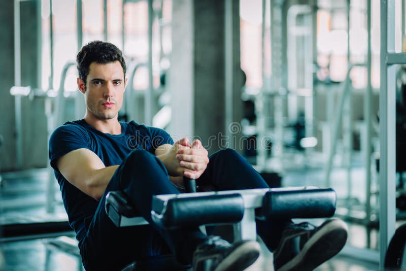 Concetto della palestra, forma fisica, sport, sano, stile di vita Il giovane misura si siede aumenta sulla macchina in abiti spor immagini stock libere da diritti Concetto della palestra, forma fisica, sport, sano, stile di vita Il giovane misura si siede aumenta sulla macchina in abiti spor immagini stock libere da diritti