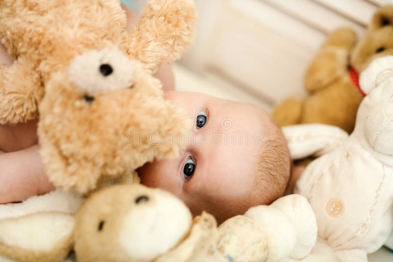 Concetto di innocenza e di infanzia Bambino coperto di suo orsacchiotto fotografia stock libera da diritti Concetto di innocenza e di infanzia Bambino coperto di suo orsacchiotto fotografia stock libera da diritti