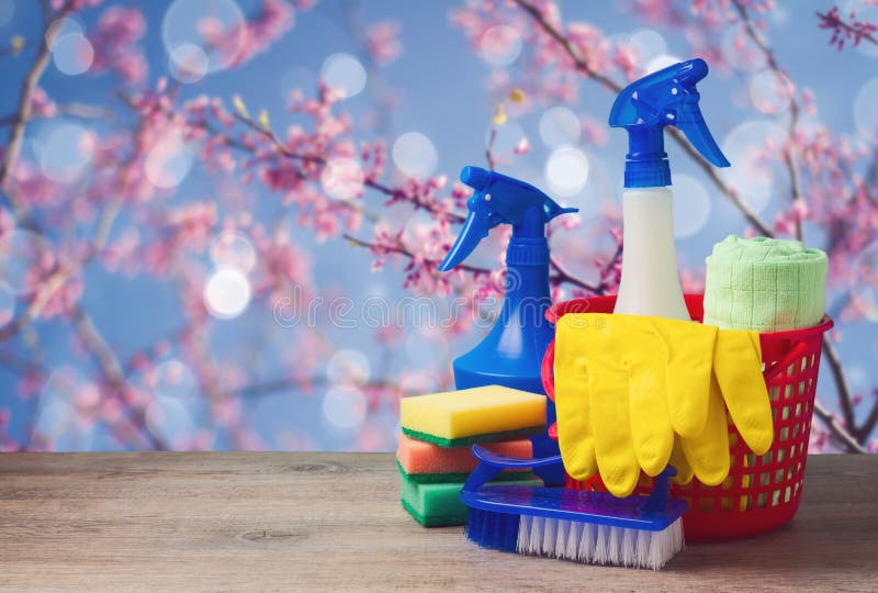 Spring cleaning tools concept with supplies over floral background. Spring cleaning tools concept with supplies over floral background