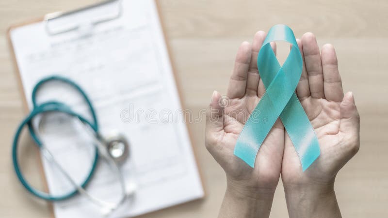 Teal ribbon awareness on woman`s hand for Ovarian Cancer, Polycystic Ovary Syndrome PCOS disease, Post Traumatic Stress Disorder PTSD, Tourette`s Syndrome, Obsessive Compulsive Disorder OCD. Teal ribbon awareness on woman`s hand for Ovarian Cancer, Polycystic Ovary Syndrome PCOS disease, Post Traumatic Stress Disorder PTSD, Tourette`s Syndrome, Obsessive Compulsive Disorder OCD.