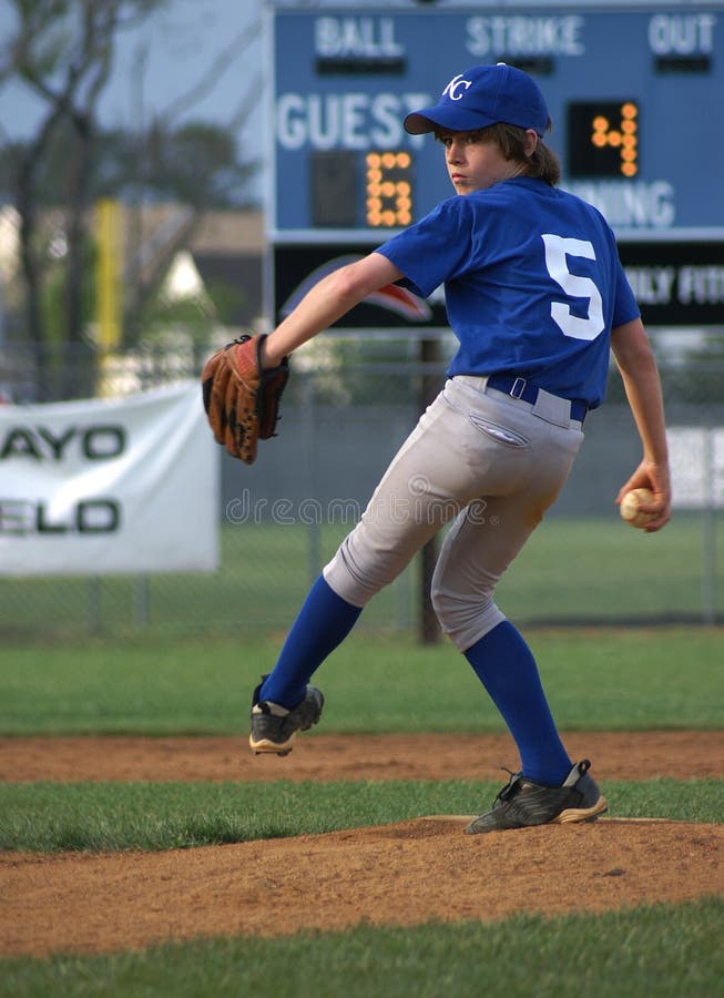 Little league pitcher winding up for the pitch. Little league pitcher winding up for the pitch