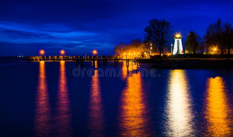 Concord Point Lighthouse and a pier at night in Havre de Grace