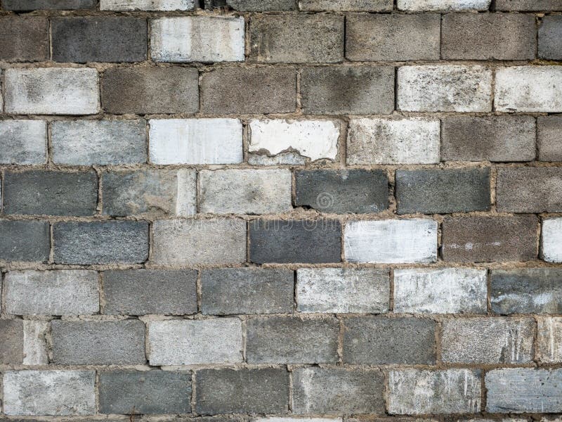 Concrete block wall texture, cinder block, gray tones, rough surface, construction material