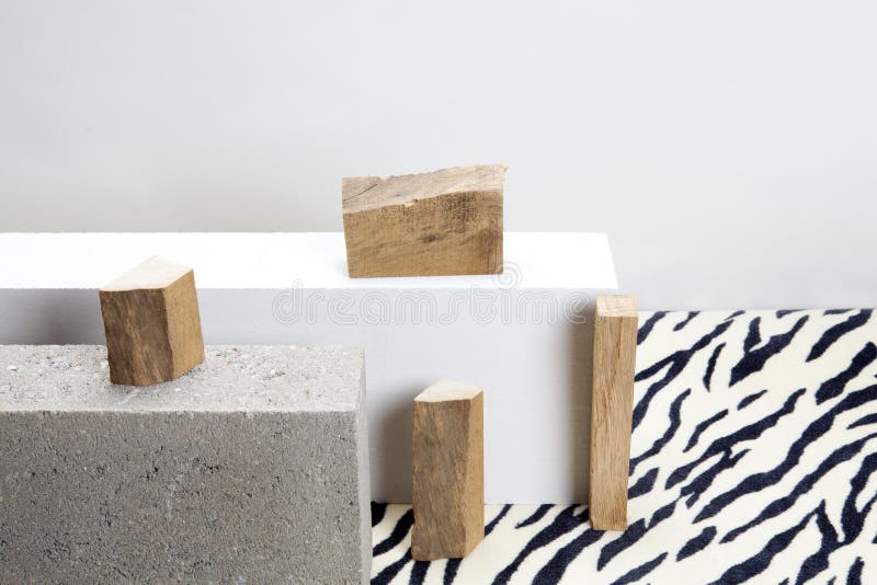 Concrete blocks, raw wood and zebra carpet. 2 concrete blocks and piece of raw wood on a zebra patterned carpet. Minimal color still life photography royalty free stock images Concrete blocks, raw wood and zebra carpet. 2 concrete blocks and piece of raw wood on a zebra patterned carpet. Minimal color still life photography royalty free stock images