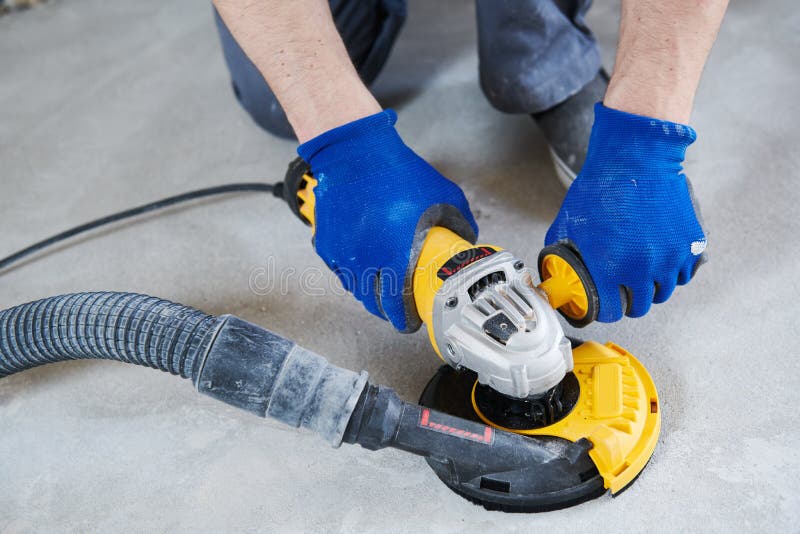 Concrete floor surface grinding by angle grinder machine