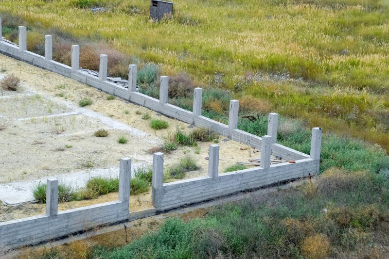 Concrete Foundation of the Future Fence. Concrete Fence Stock Photo