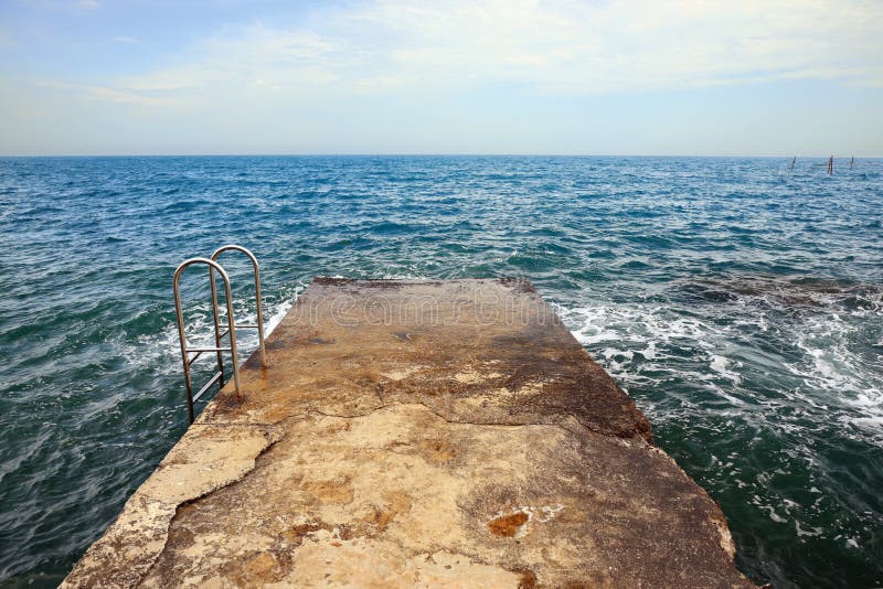 Old Concrete Pier Or Breakwater At Sea Beach Coast Line, First Person