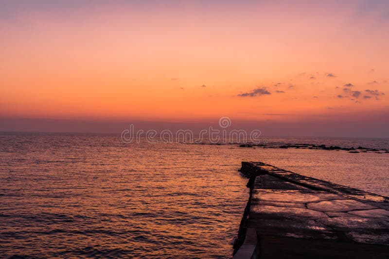 Concrete Pier Or Jetty On A Blue Sea. Hills On Background Stock Image