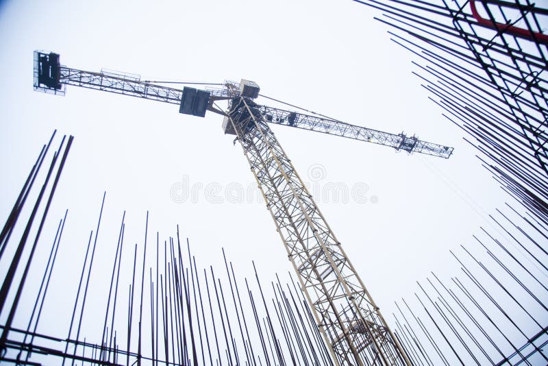 Concrete pillars on industrial construction site. Building of skyscraper with crane, tools and reinforced steel bars royalty free stock images Concrete pillars on industrial construction site. Building of skyscraper with crane, tools and reinforced steel bars royalty free stock images