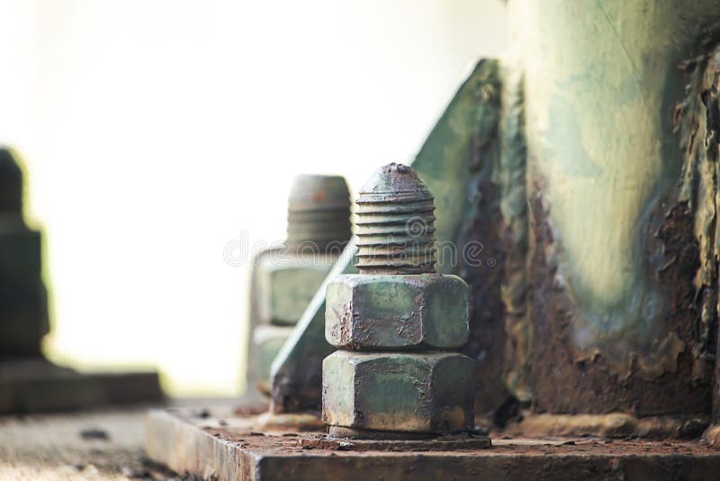 Concrete post head nut with rusty old steel stock image
