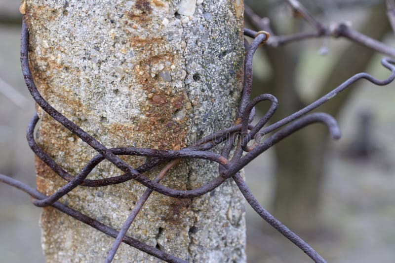 Concrete post with rusty wire stock photography
