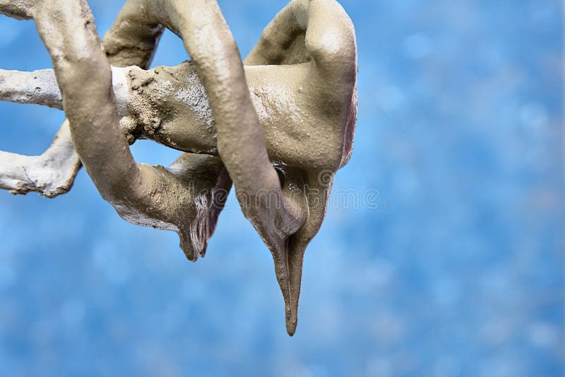 Concrete solution flows down from the mixer. close-up. blue background stock images