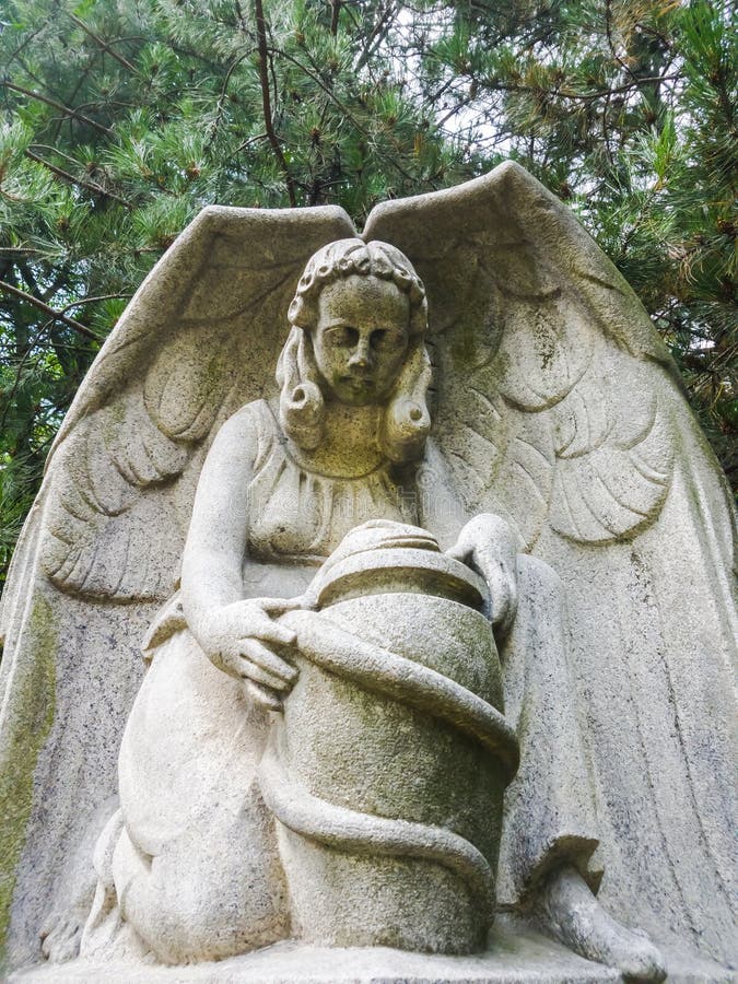 Concrete statue of an angel with a jug in the park royalty free stock photography Concrete statue of an angel with a jug in the park royalty free stock photography