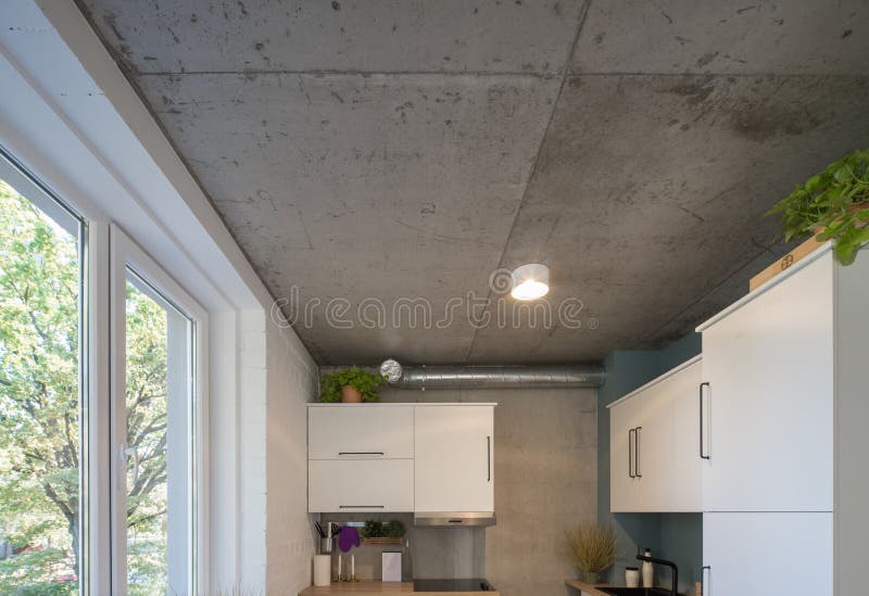 Concrete Ceiling and Lighting in a Modern Apartment. Concrete Style in