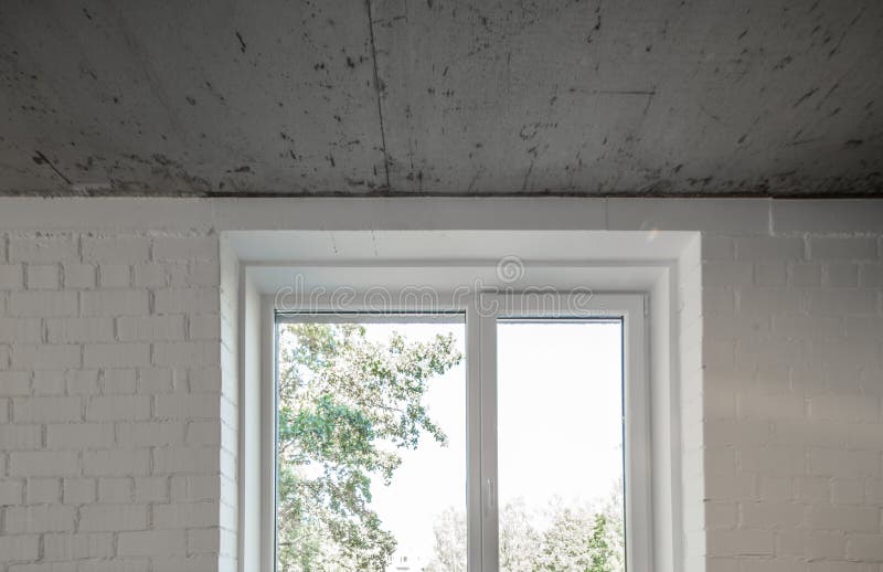 Concrete Ceiling and Lighting in a Modern Apartment. Concrete Style in