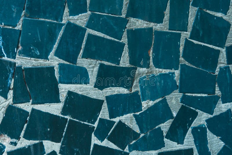 A Concrete Wall with Fragments of Blue Ceramic Tiles Stained Stock