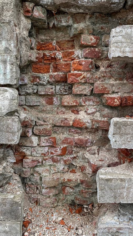 Concrete Wall Inside a Red Brick. Hole in the Wall. the Cement Blocks are Destroyed Stock Photo