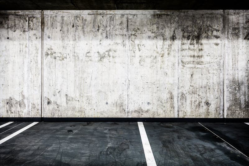 Parking garage underground interior background or texture. Concrete grunge wall and asphalt road, industrial retro vintage interior. Parking garage underground interior background or texture. Concrete grunge wall and asphalt road, industrial retro vintage interior.