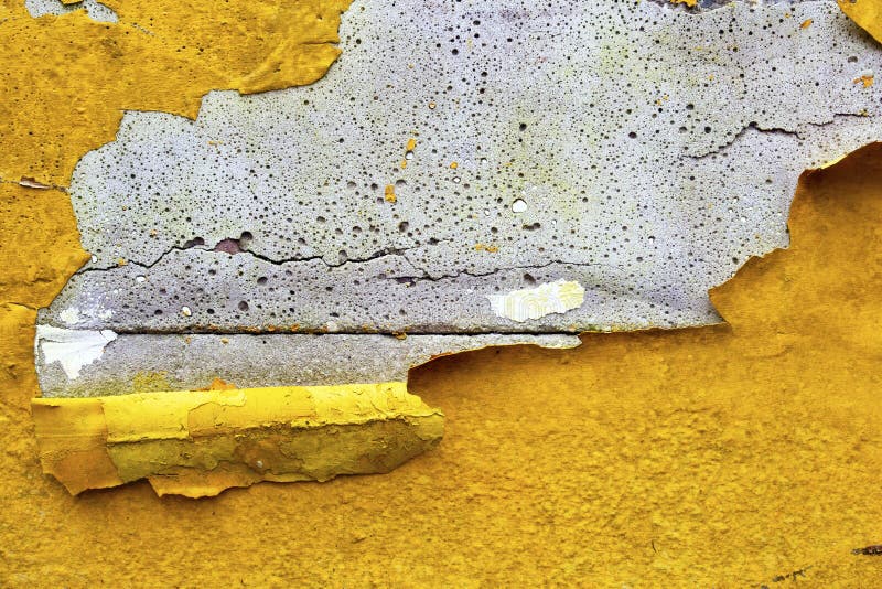Concrete wall with yellow, orange peeling paint old cracked damaged rough bright background texture stock images Concrete wall with yellow, orange peeling paint old cracked damaged rough bright background texture stock images