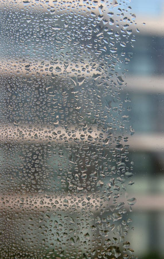 Water droplets between double-glazing panes captured in close detail. Water droplets between double-glazing panes captured in close detail.