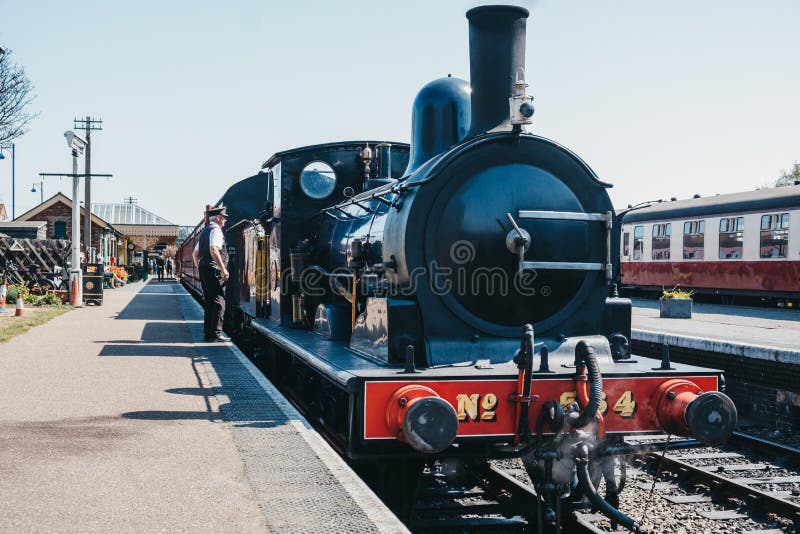 Conductor standing by the cab of The Poppy Line train, Sheringham, Nortfolk, UK stock photos Conductor standing by the cab of The Poppy Line train, Sheringham, Nortfolk, UK stock photos