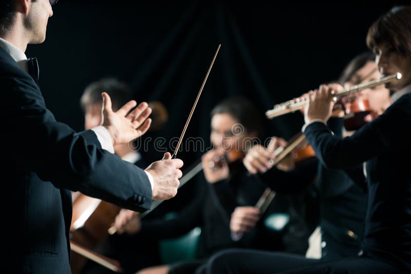 Conduttore che dirige orchestra sinfonica fotografia stock Conduttore che dirige orchestra sinfonica fotografia stock