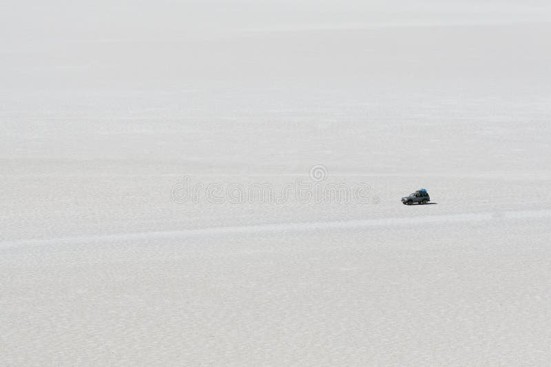 Jeep crossing the high altitude salt flats of Uyuni in Bolivian Andes. Jeep crossing the high altitude salt flats of Uyuni in Bolivian Andes