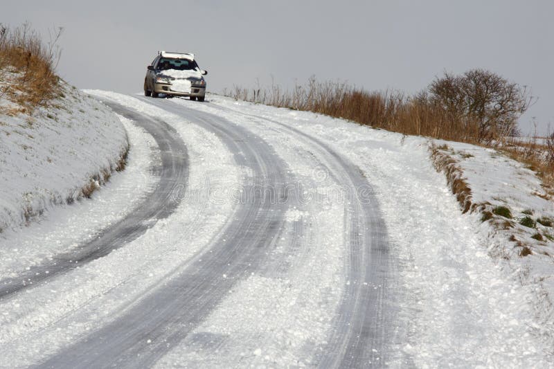 Winter driving on a snow covered road in the countryside of North Yorkshire in the north of England. Winter driving on a snow covered road in the countryside of North Yorkshire in the north of England