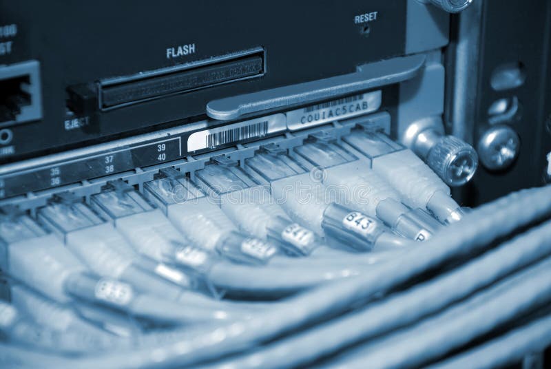 Image of network router network connectors in a computer room datacenter. Image of network router network connectors in a computer room datacenter